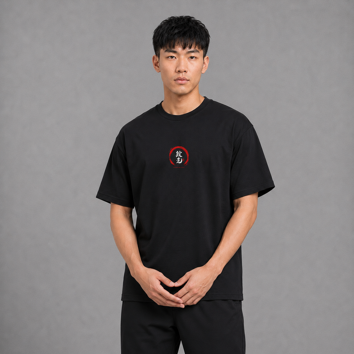 Front view of a model wearing the black Gyomei Faith T-shirt with a small chest graphic inspired by Demon Slayer