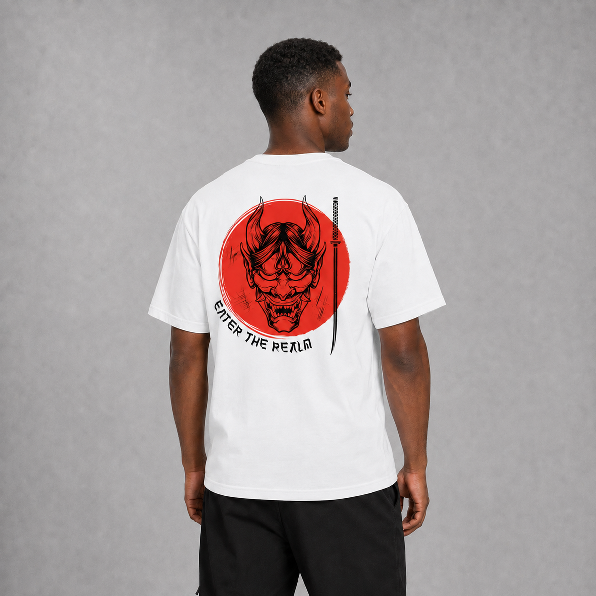 Back view of a model wearing the white Enter the Realm T-shirt with Hannya mask artwork
