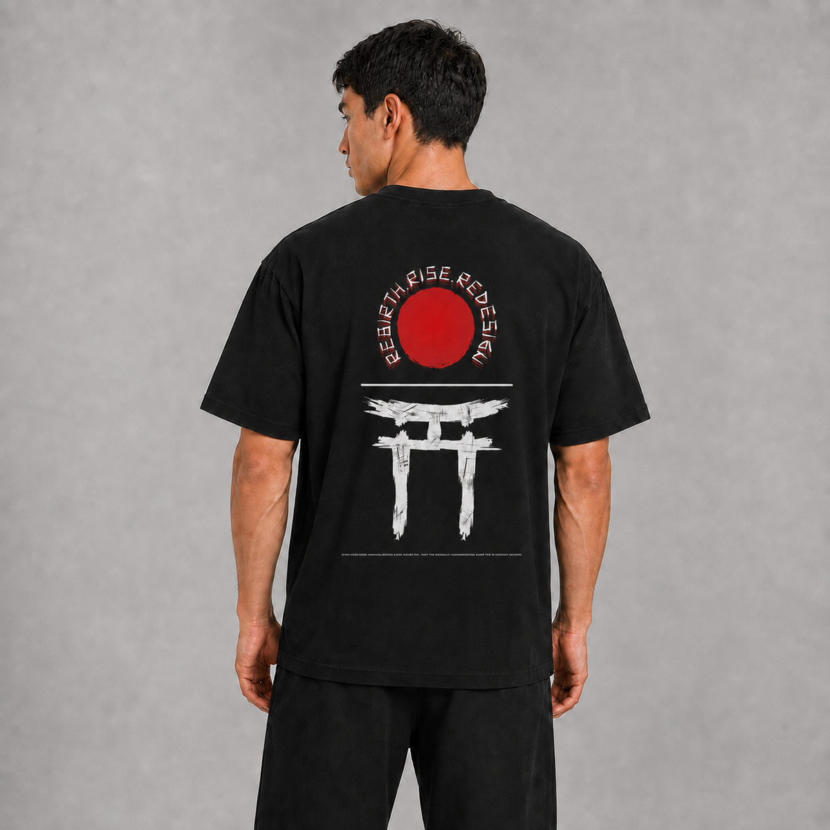 Back view of a model wearing the black Gate of Becoming T-shirt with red sun and torii gate artwork