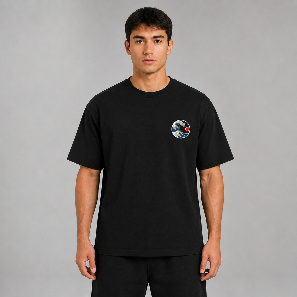 Front view of a model wearing the black Glitched Kanagawa T-shirt with small wave chest graphic