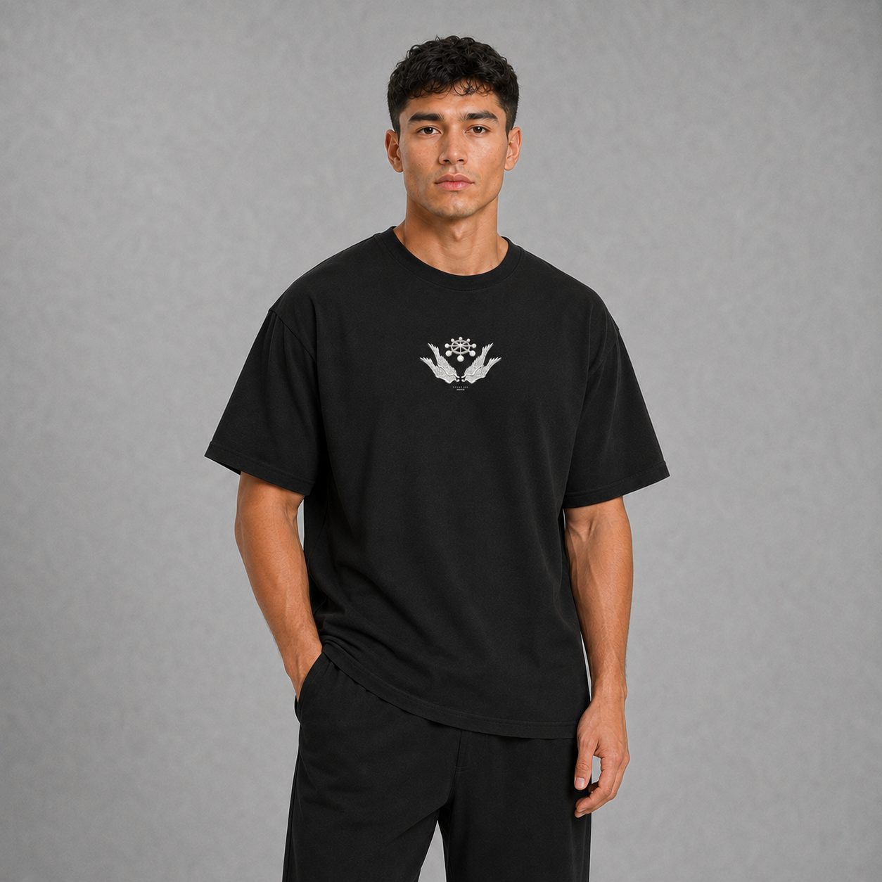 Front view of a model wearing the black Mahoraga T-shirt with a small chest graphic inspired by Jujutsu Kaisen