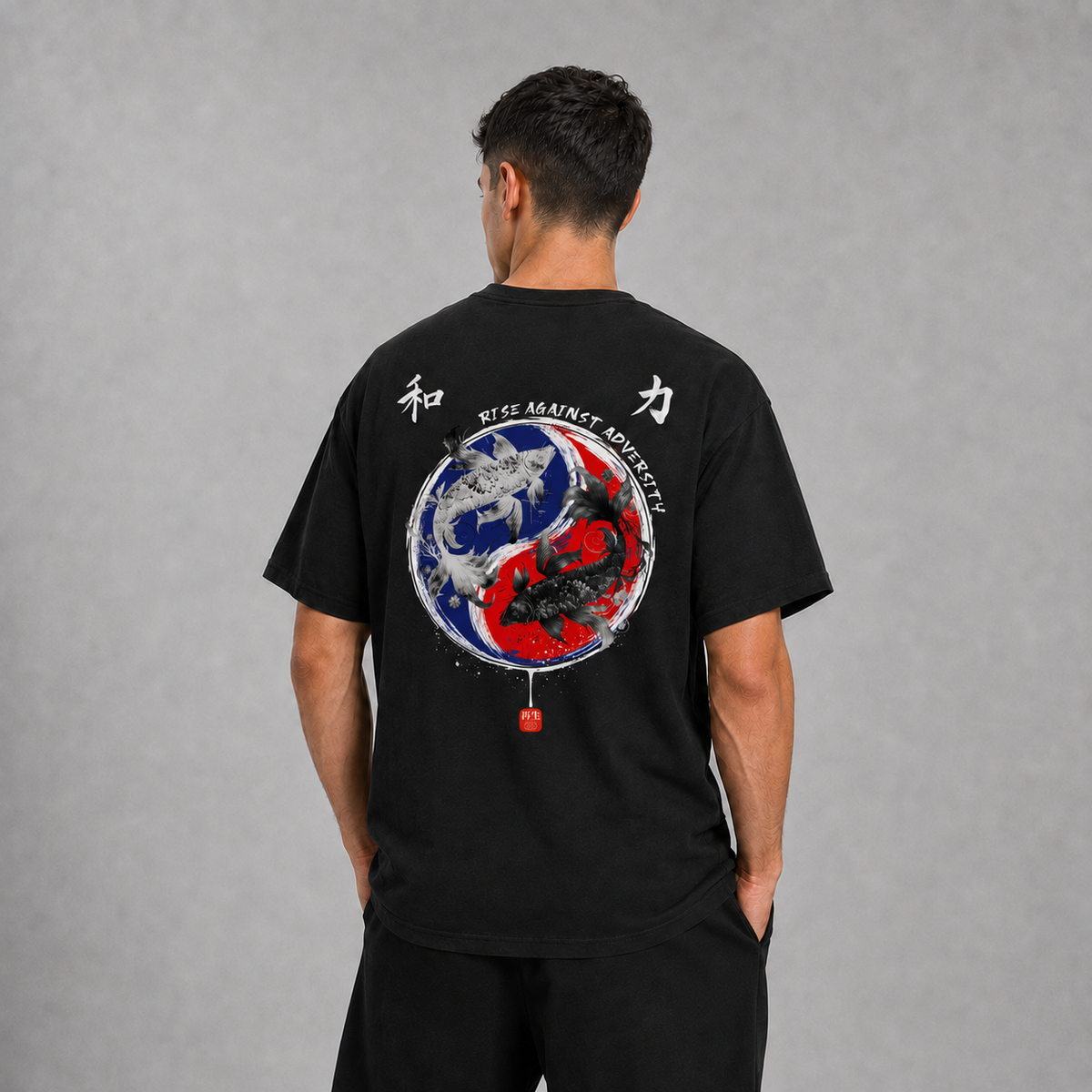Back view of a model wearing the black Koi Path T-shirt with yin-yang koi artwork