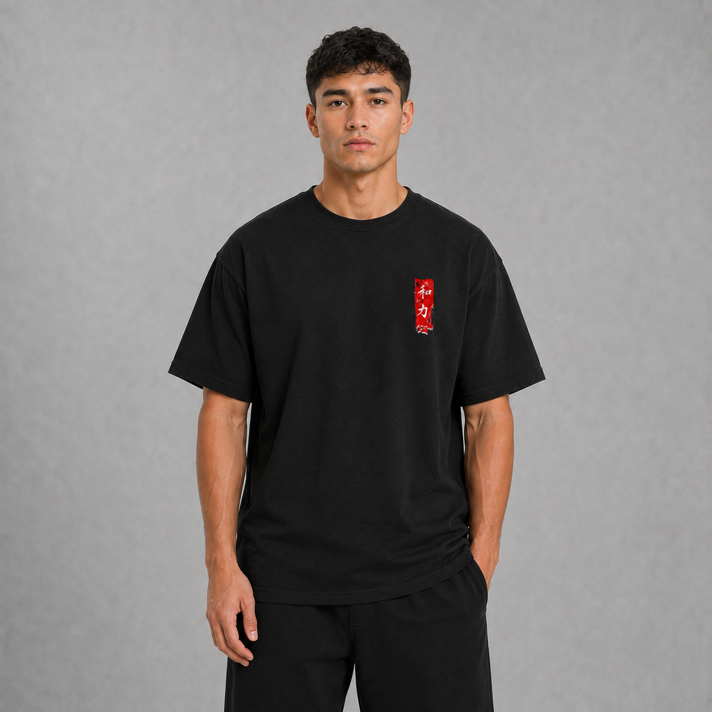 Front view of a model wearing the black Koi Path T-shirt with minimal red chest graphic
